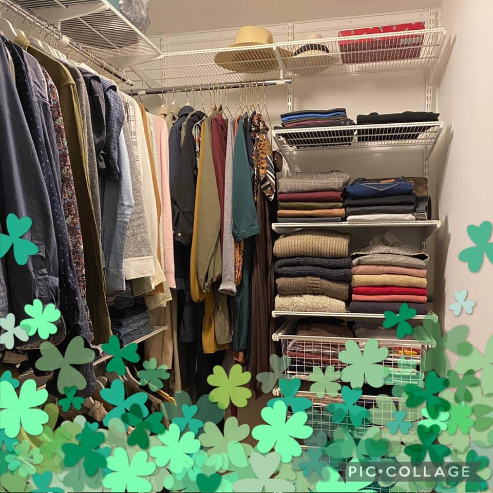 A neat closet full with clothes.
